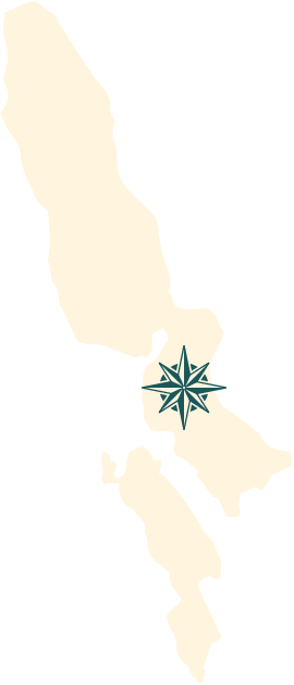 The shape of Rhode Island overlaid with a map compass