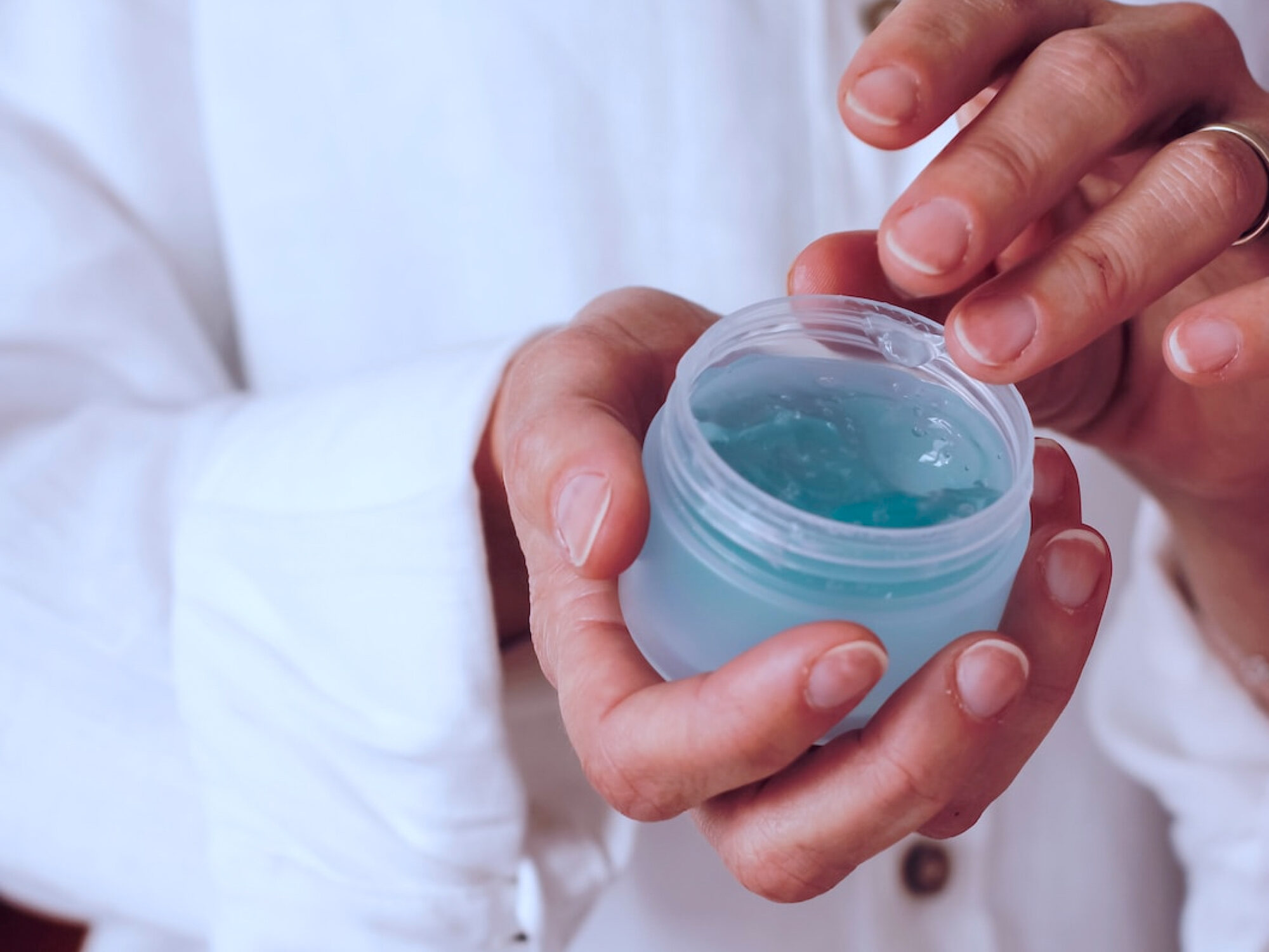 A provider at Harbour Direct Primary Care showing the photographer just one of the products they offer for personalized skin care in Jamestown, RI.